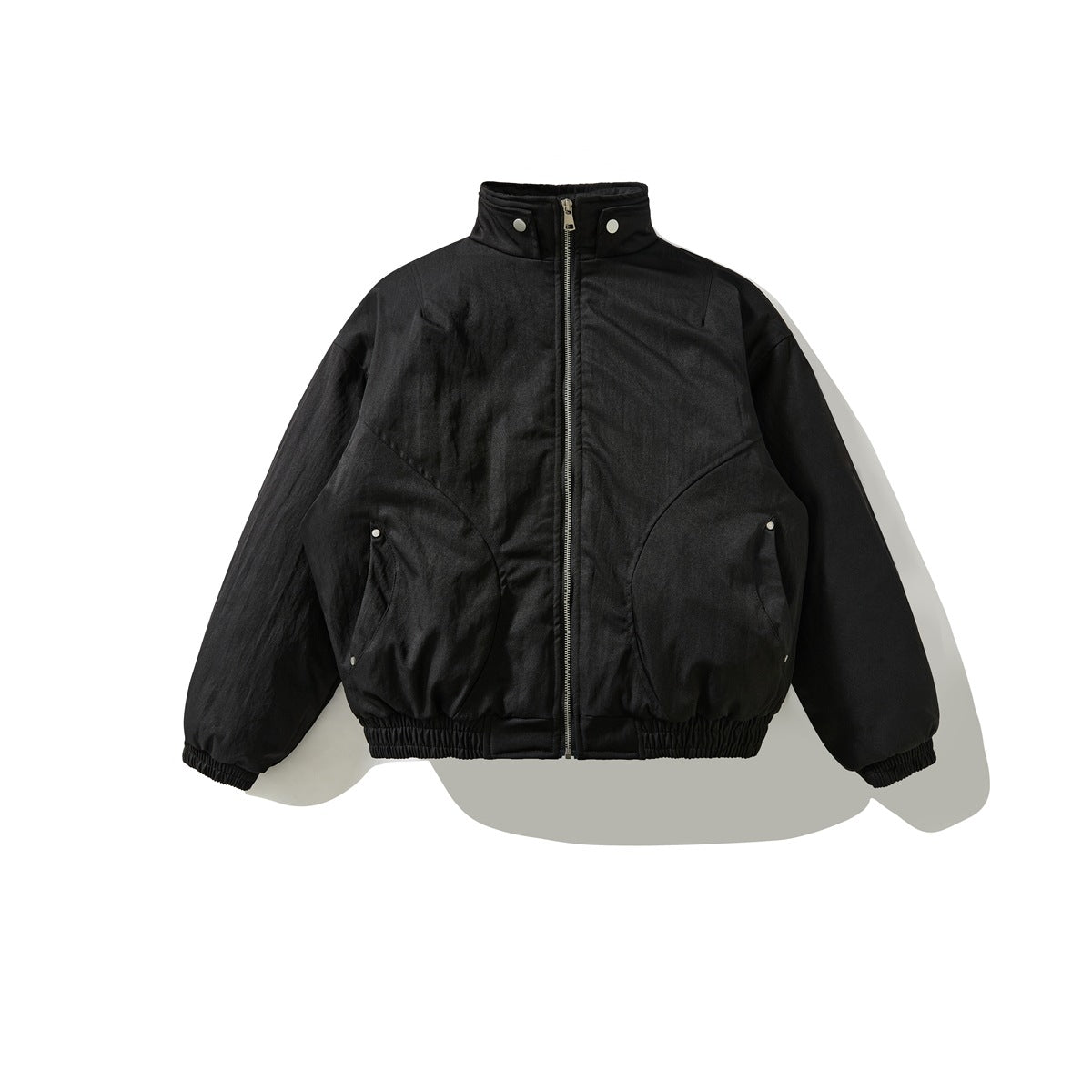 Black zip-front stand-collar padded bomber jacket with curved seams and elastic cuffs, flat lay