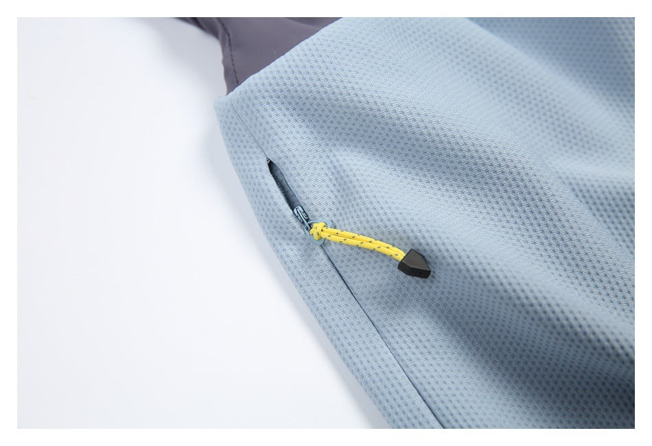 Close-up of a side zipper with a bright yellow pull on light blue textured fabric.