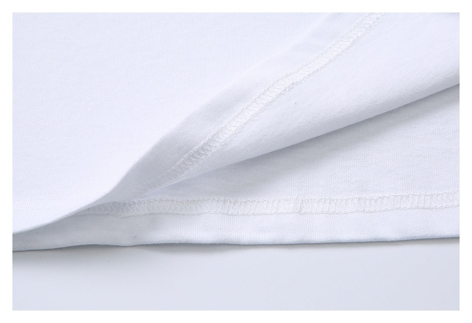 Close-up of the inside of a white shirt hem, showing overlocked stitching.
