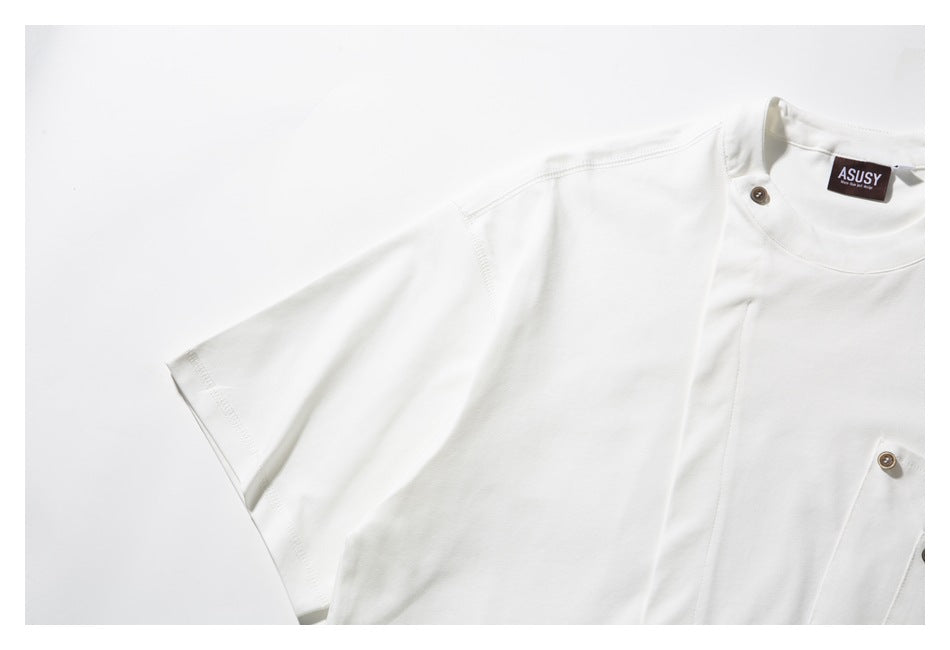 Close-up of a white T-shirt sleeve and upper chest, showing seam details, a button, and part of the neck label.
