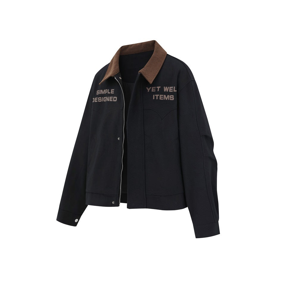 Front three-quarter view of a black jacket with a brown collar, zip front, snap details, and printed lettering.