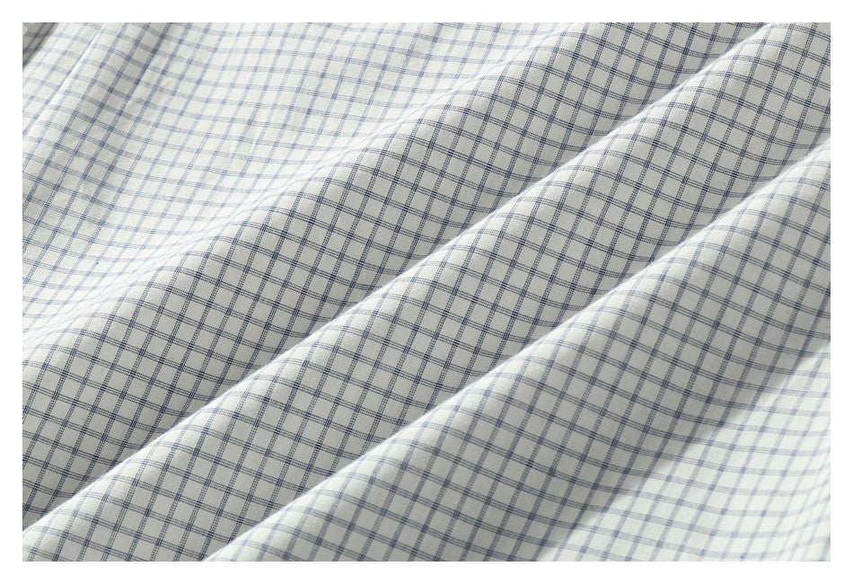 Close-up of white fabric patterned with a fine blue-gray check.