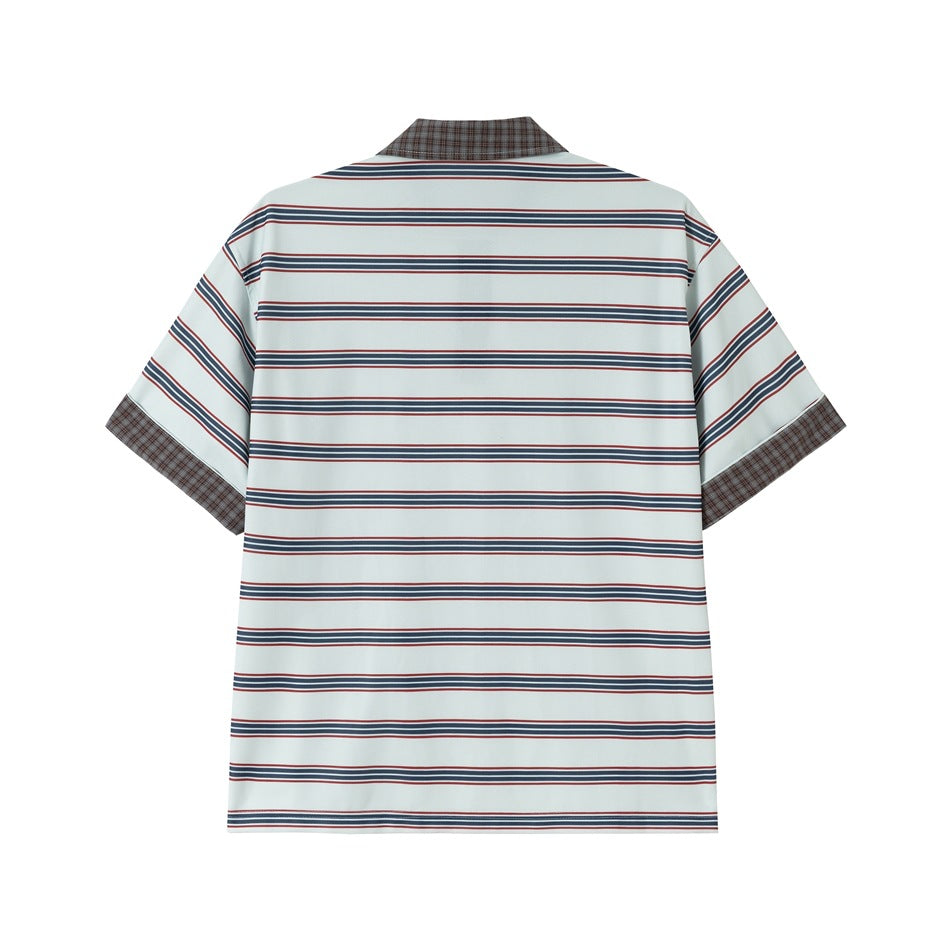 Back view of pale blue polo shirt with navy and red horizontal stripes and brown plaid collar and cuffs