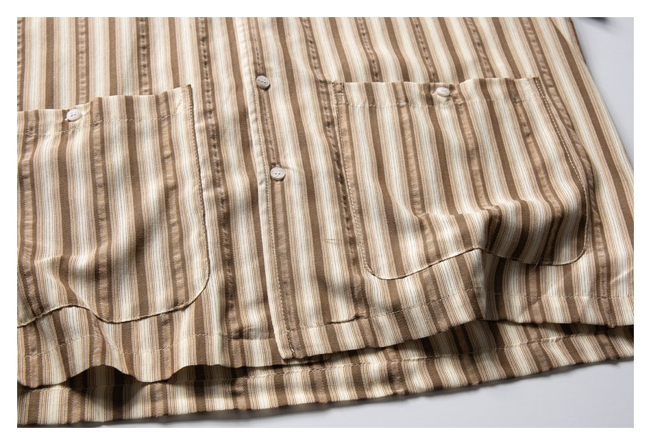 Close-up of the striped shirt’s front buttons, two chest pockets, and hem.