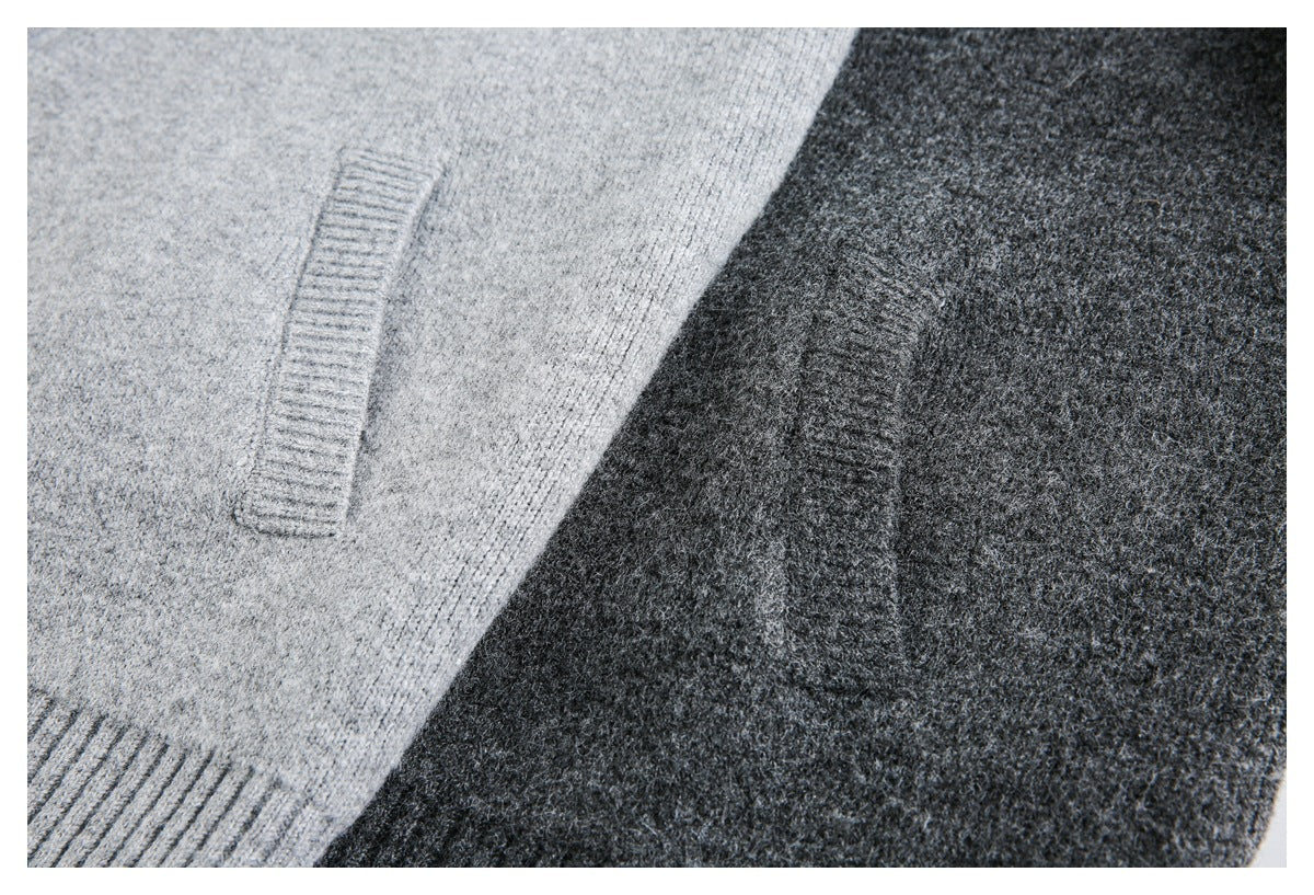 Close-up of light gray and charcoal knit fabric with ribbed trim.