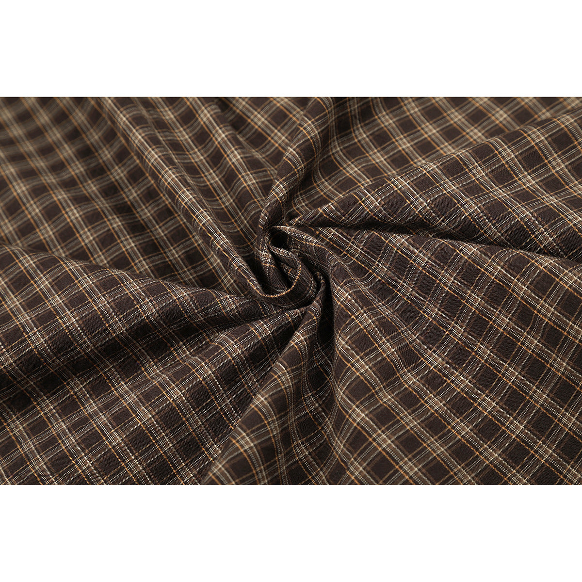 Close-up of brown plaid fabric gathered to show its checked pattern.