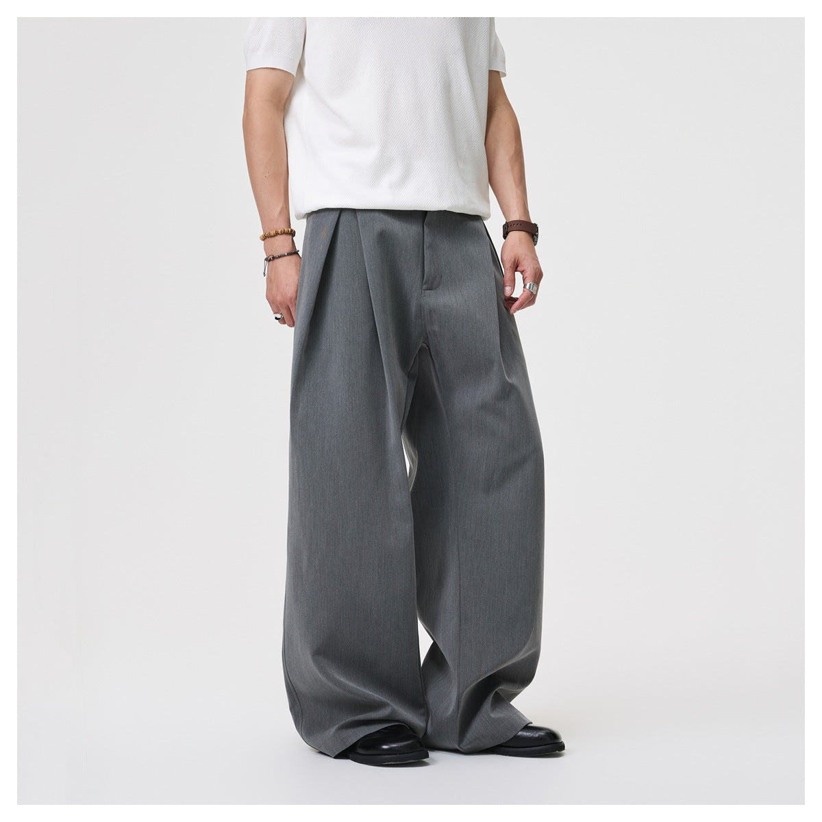 Model wearing charcoal gray wide-leg trousers, shown from the front against a light background.