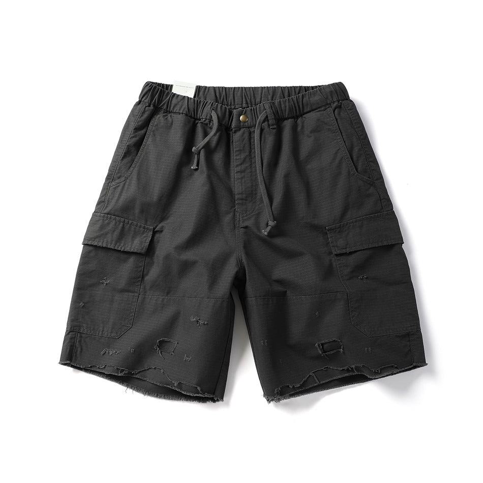Black-gray cargo shorts flat lay with drawstring waist, side flap pockets and distressed frayed hem