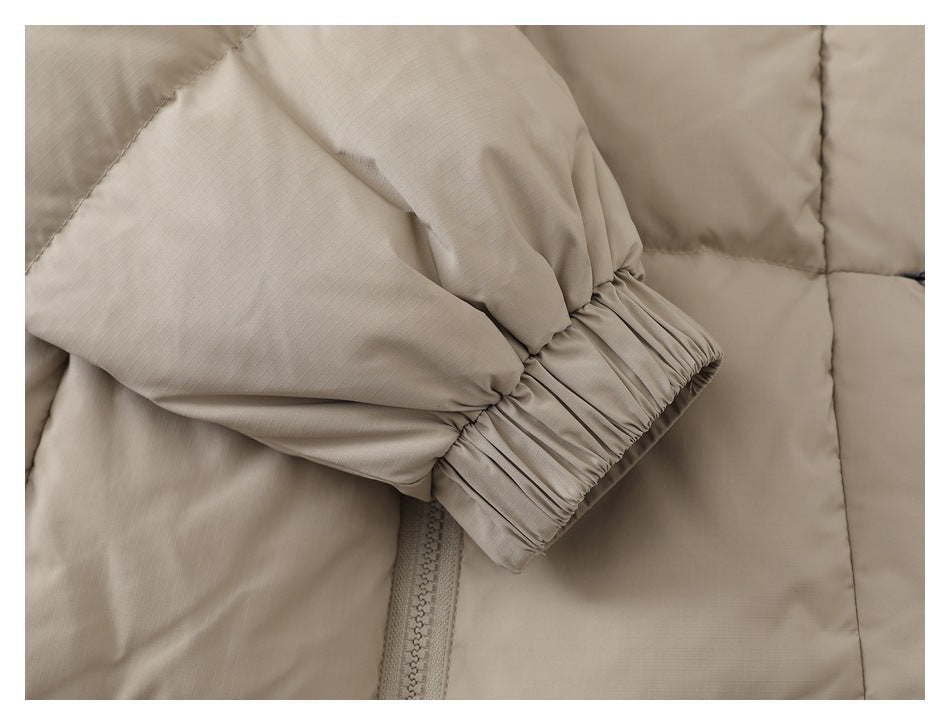 Close-up of the taupe jacket's gathered elastic sleeve cuff.