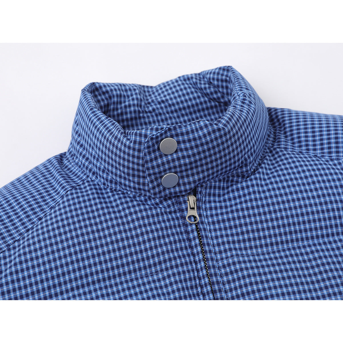 Close-up of a blue checked jacket's stand collar, silver snaps and front zipper.