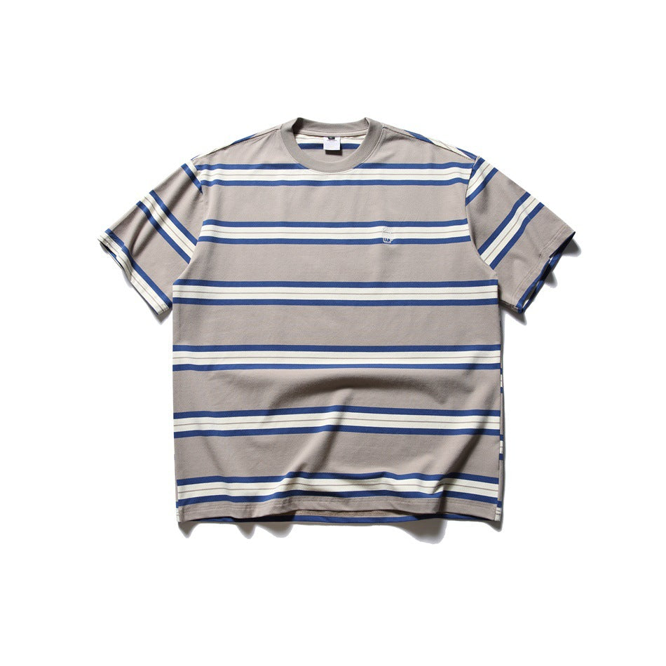 Front view of a taupe short-sleeve crew-neck T-shirt with blue and ivory horizontal stripes and a small chest emblem.
