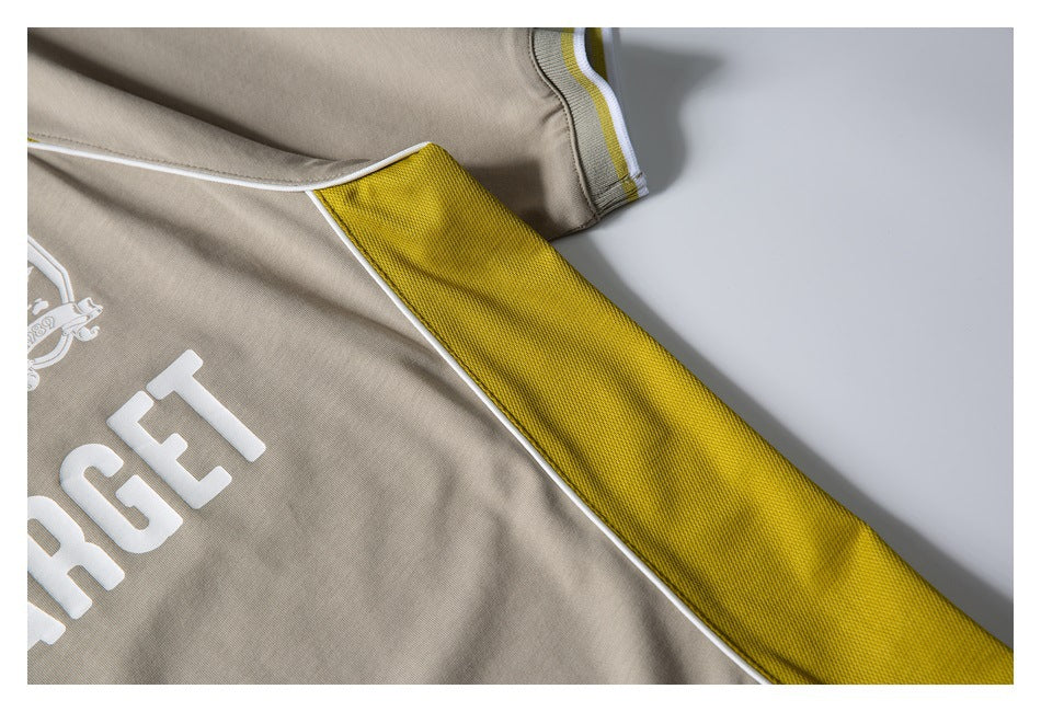 Close-up of a textured yellow shirt insert bordered by white piping on the beige garment.