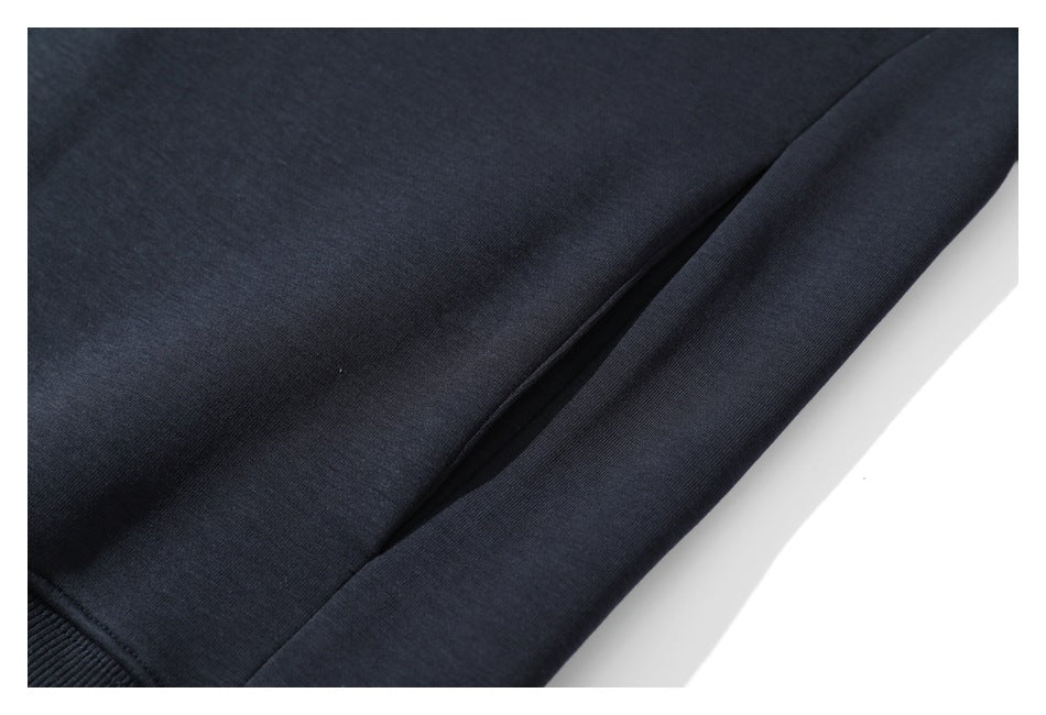 Close-up of a dark navy garment's side seam and lower edge with a ribbed hem.