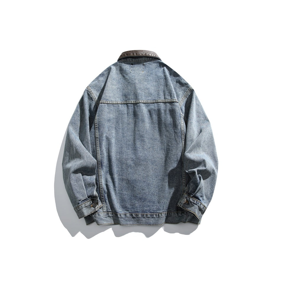Back view of a blue denim jacket with a dark brown collar, seam detailing, and buttoned cuffs.