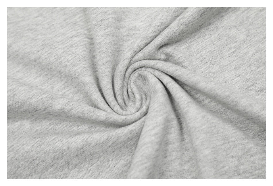 Close-up of heather-gray garment fabric gathered into a spiral fold.