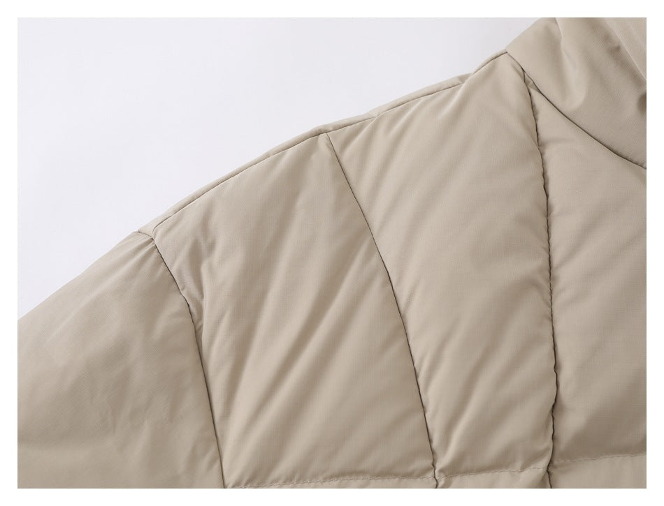 Close-up of the taupe jacket's shoulder and quilted sleeve panels.