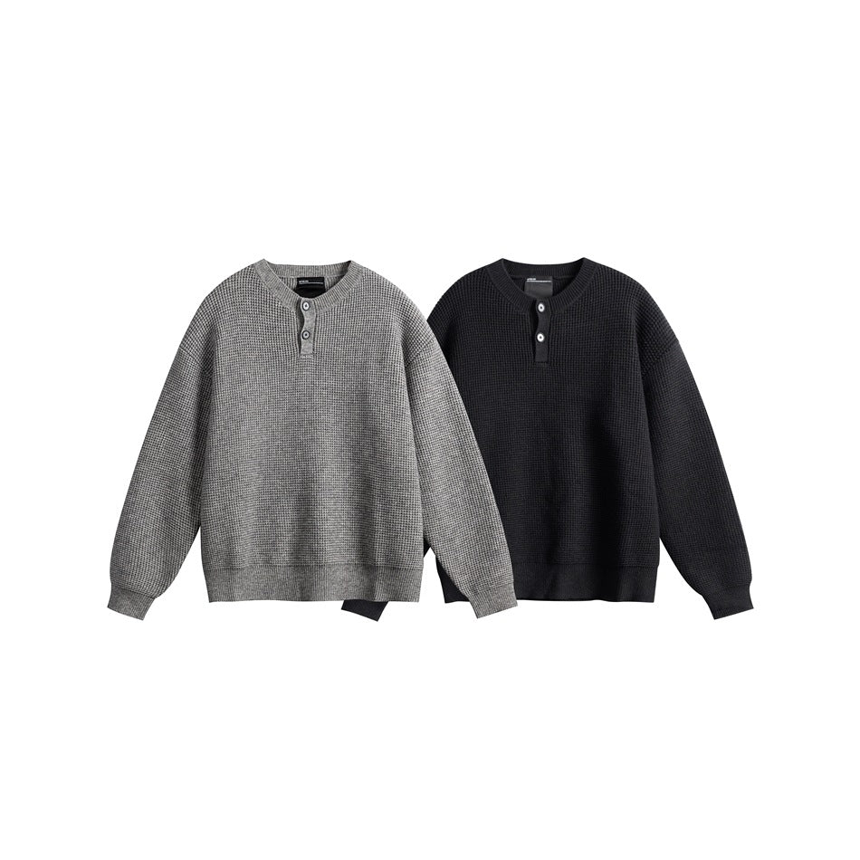 Two button-neck waffle-knit sweaters shown from the front in gray and black.