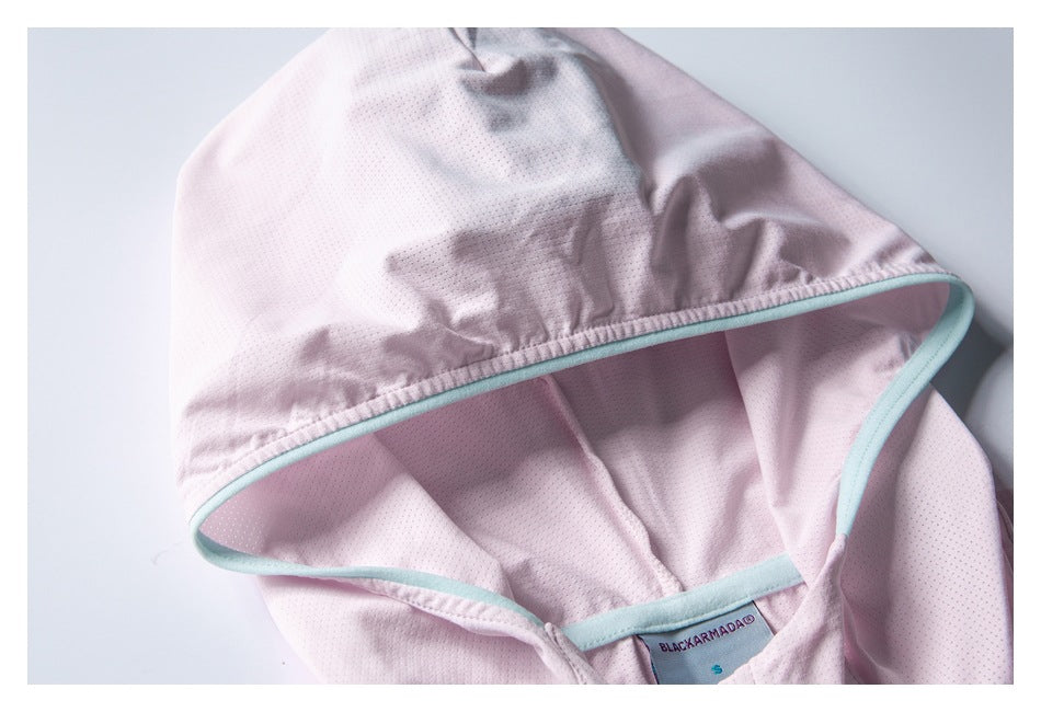Close-up of a pale pink hood with tiny perforations, mint edging, and a BLACKARMADA size S neck label.