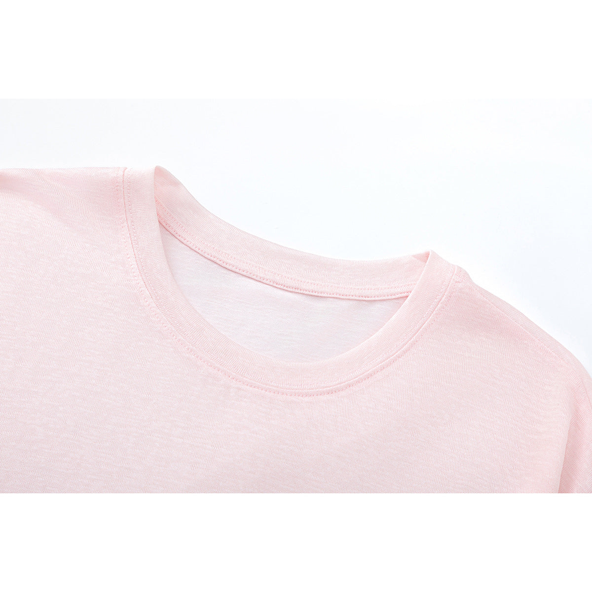 Close-up of a pale pink crew-neck shirt showing the collar and shoulder seams.