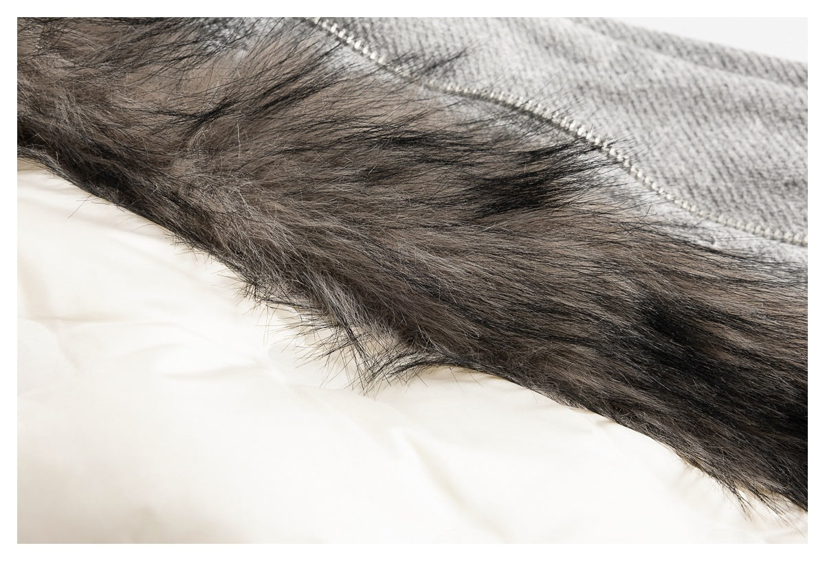 Close-up of dark furry trim along the edge of gray garment fabric.