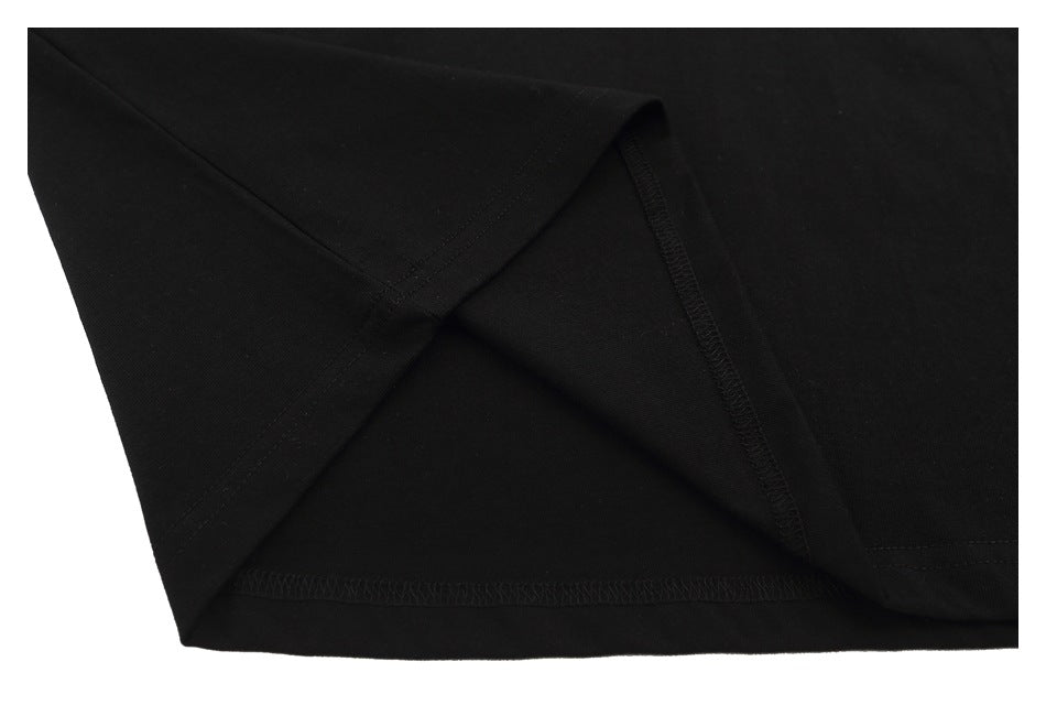Close-up of a black T-shirt hem and side seam with visible stitching.
