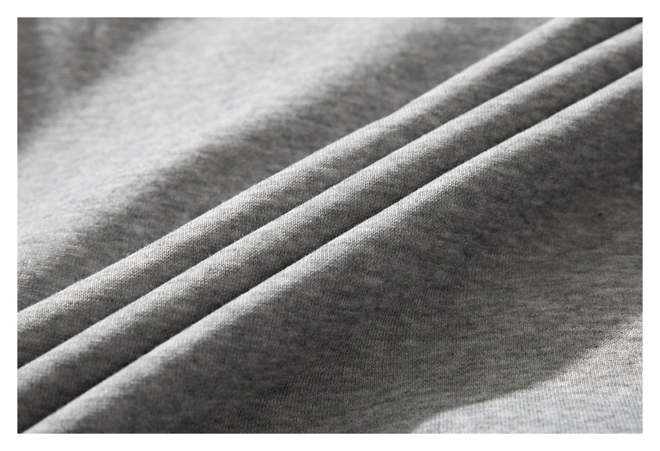 Close-up of the heather gray garment fabric arranged in diagonal folds.