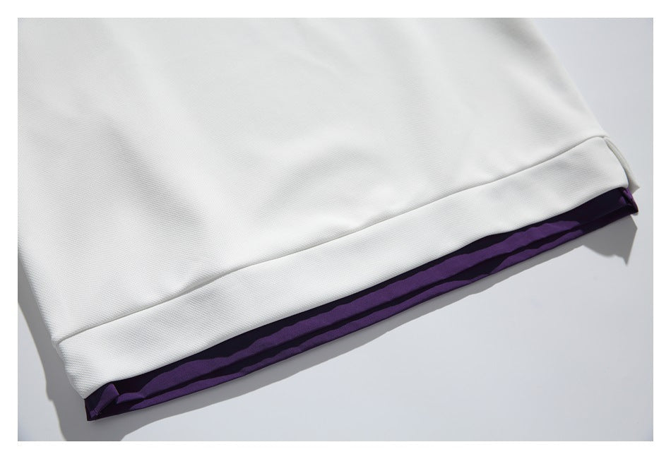 Close-up of a white garment hem with a narrow dark purple layer visible underneath.
