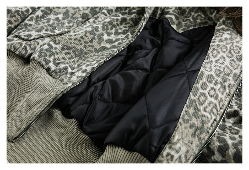 Open animal-print jacket showing a black quilted lining, zipper, snap pocket, and ribbed cuff.