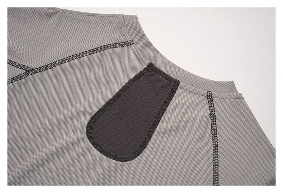 Close-up of the gray top's back neckline and dark rounded patch with contrast stitching.