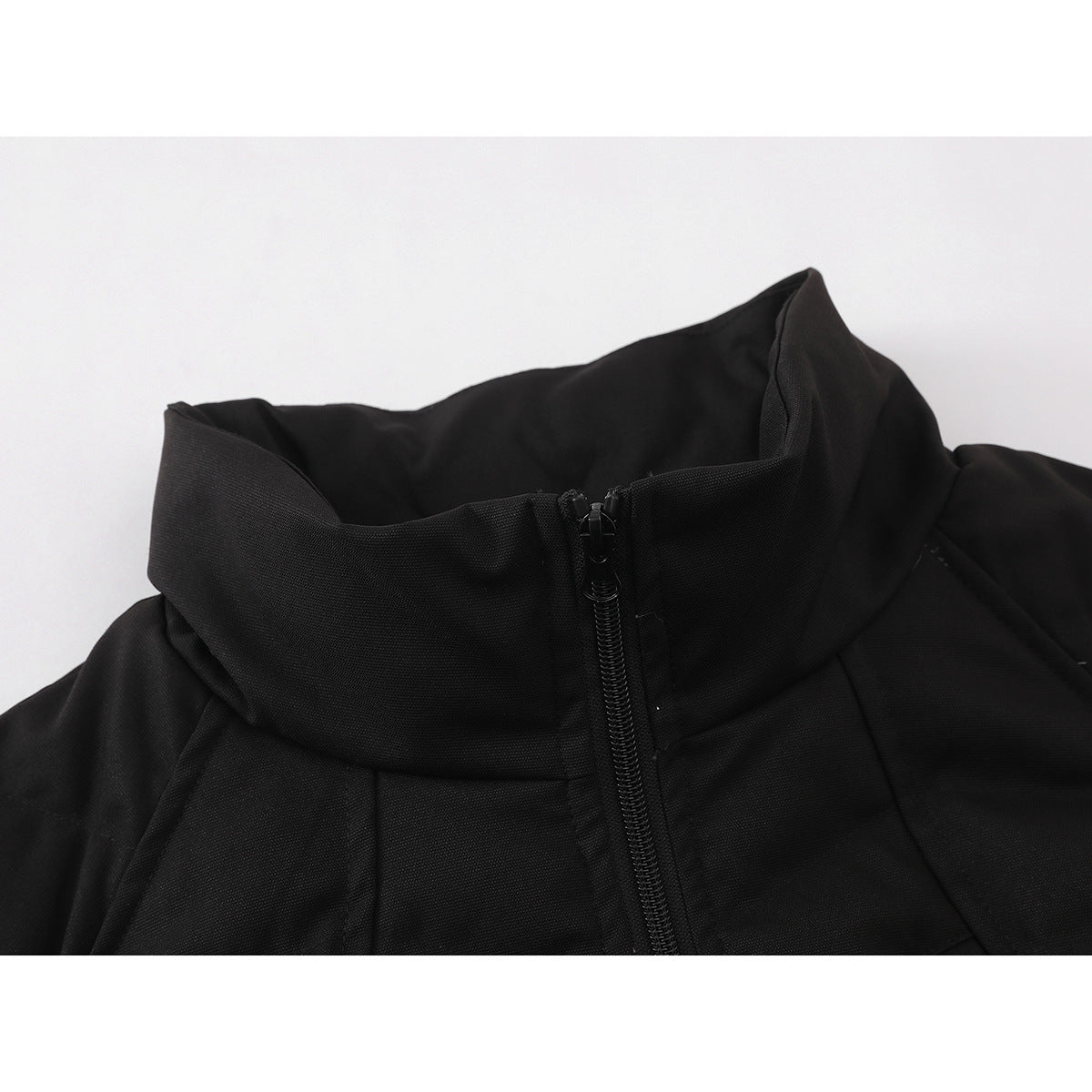 Close-up of a black jacket's high stand collar and front zipper.