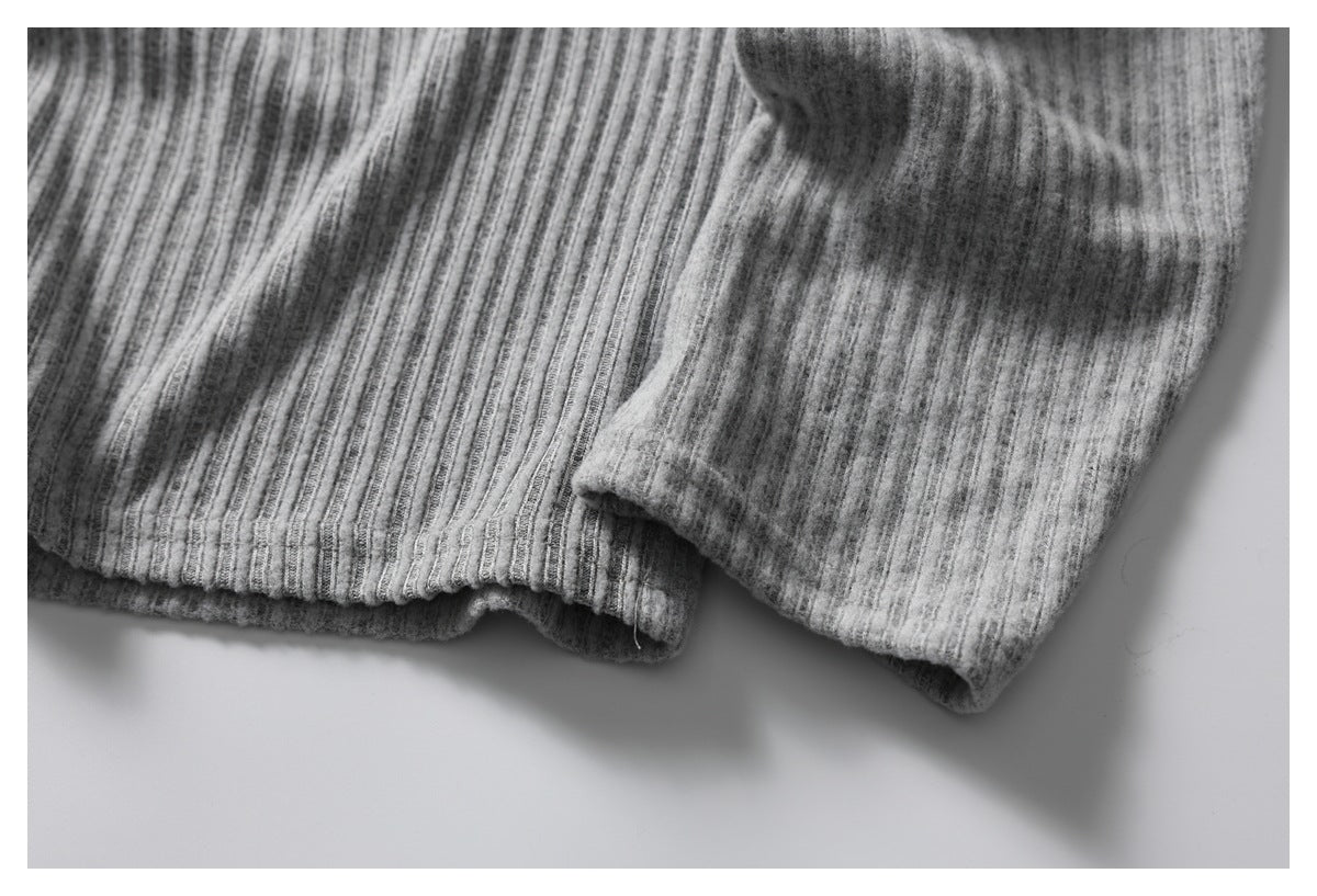Close-up of a heather gray ribbed garment hem and sleeve cuff.