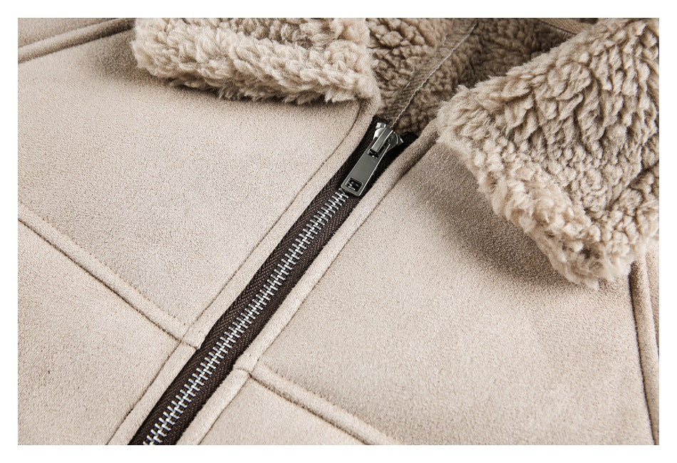 Close-up of a taupe jacket's metal front zipper, fleece collar, and seam details.