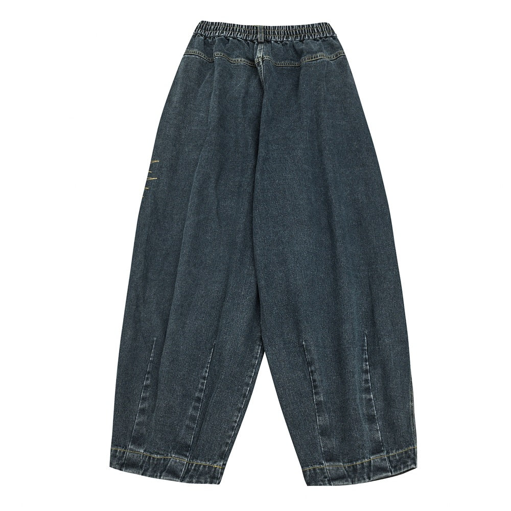 Back view of dark charcoal wide-leg denim pants with an elastic waistband and cropped hems.