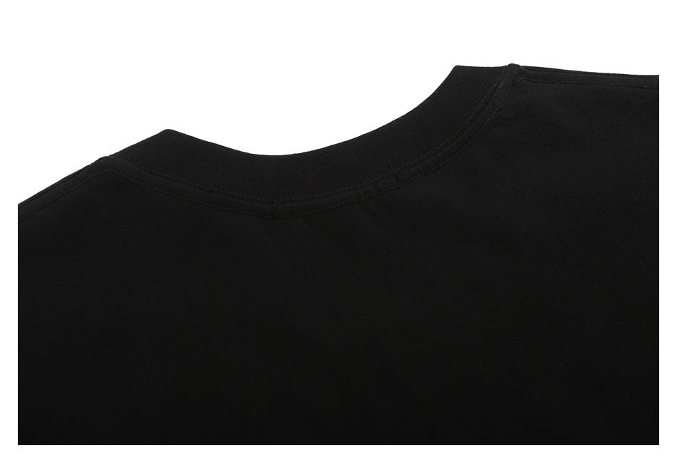 Close-up of the plain black T-shirt's back neckline and shoulder seams.