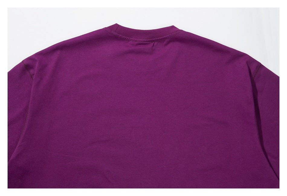 Back view of a plain purple short-sleeve crewneck shirt laid flat.