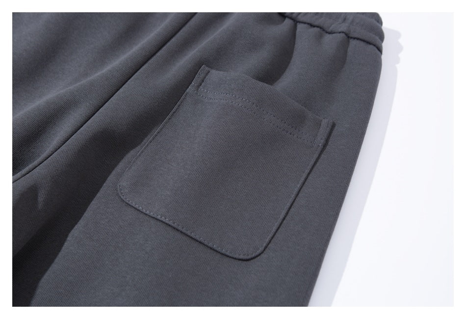 Close-up of a rectangular patch pocket on charcoal jogger pants.