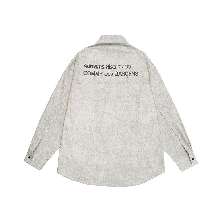 Back view of a silver gray washed-look long-sleeve shirt with a distressed text print across the upper back