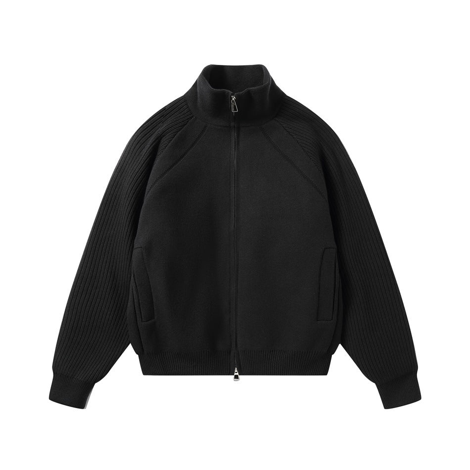 Black knit stand-collar zip jacket with ribbed raglan sleeves, ribbed hem and cuffs, and front pockets, flat lay