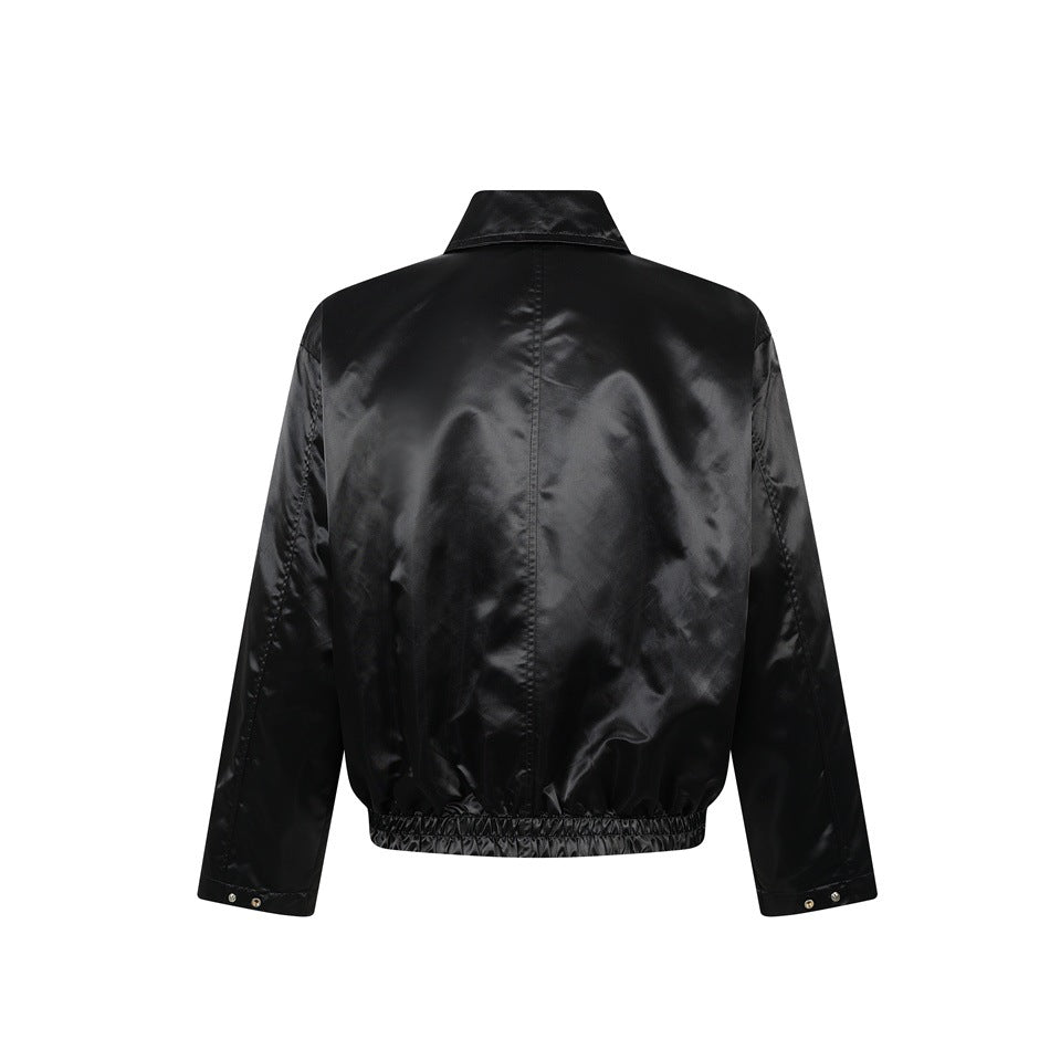 Back view of black satin-finish jacket with center seam, elastic hem and snap-button cuffs