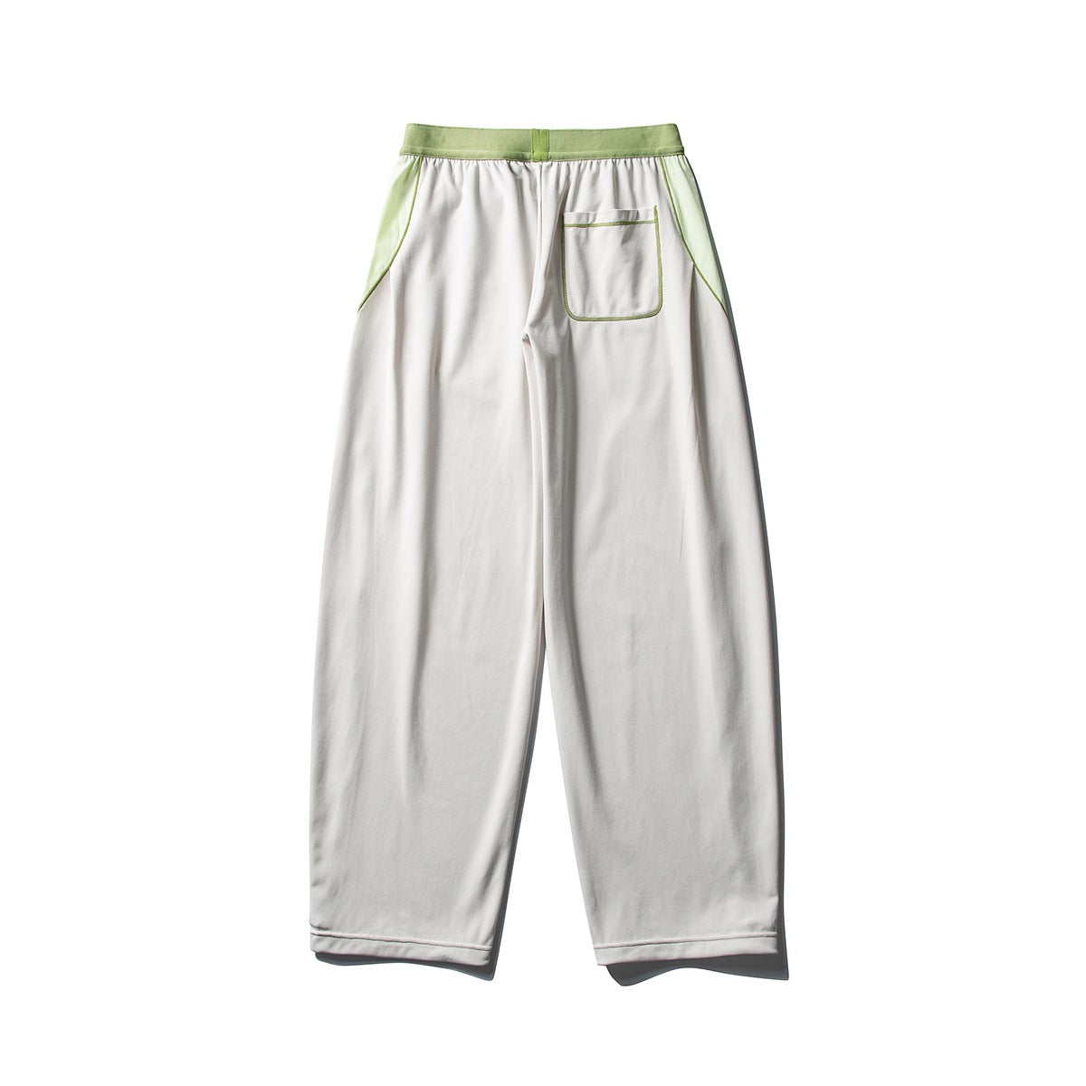 Back view of white wide-leg pants with a light green waistband, side panels, and a single patch pocket.
