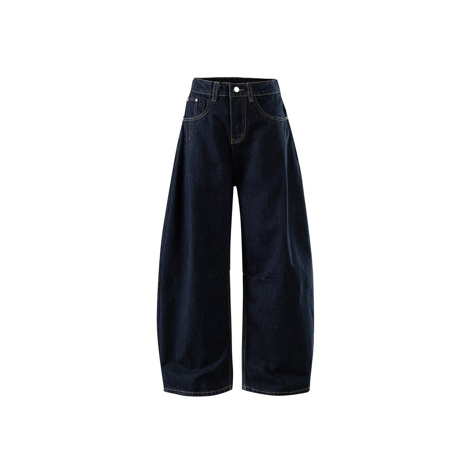 Front view of dark indigo wide-leg barrel jeans with contrast stitching, button waistband and knee seam