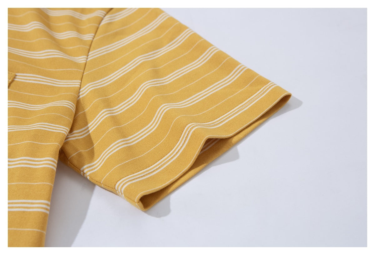 Close-up of the short sleeve and folded cuff of a mustard yellow T-shirt with thin white stripes.