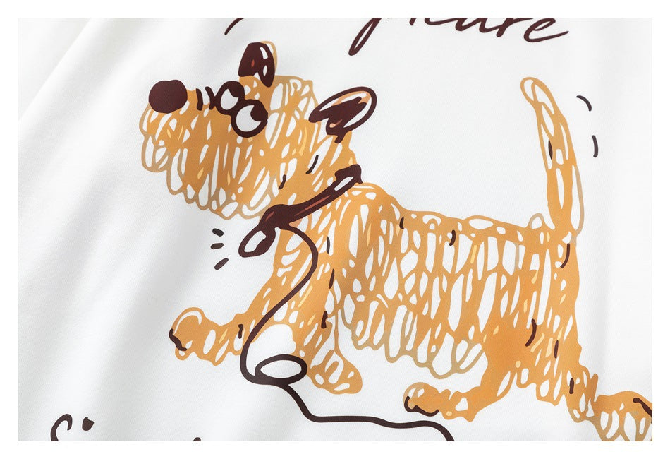 Close-up of a tan cartoon dog graphic printed on white fabric.
