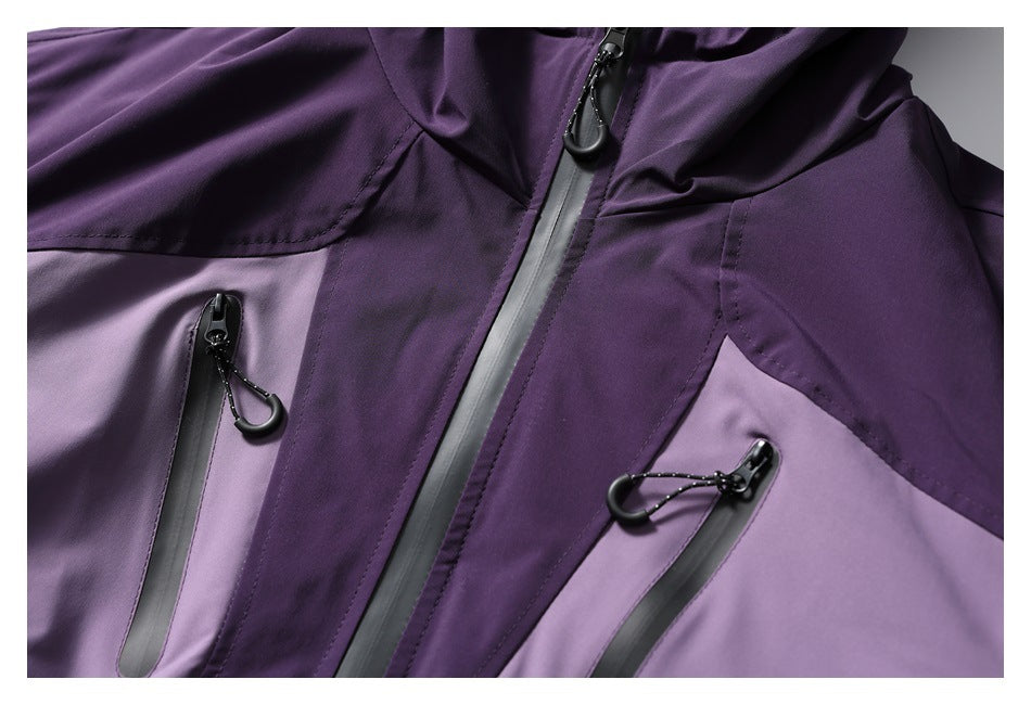 Close-up of a purple jacket front with a central zipper and two vertical zip pockets.