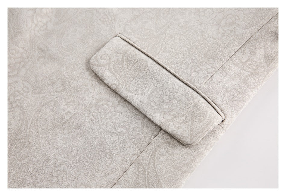 Close-up of a welt pocket on light taupe paisley fabric.