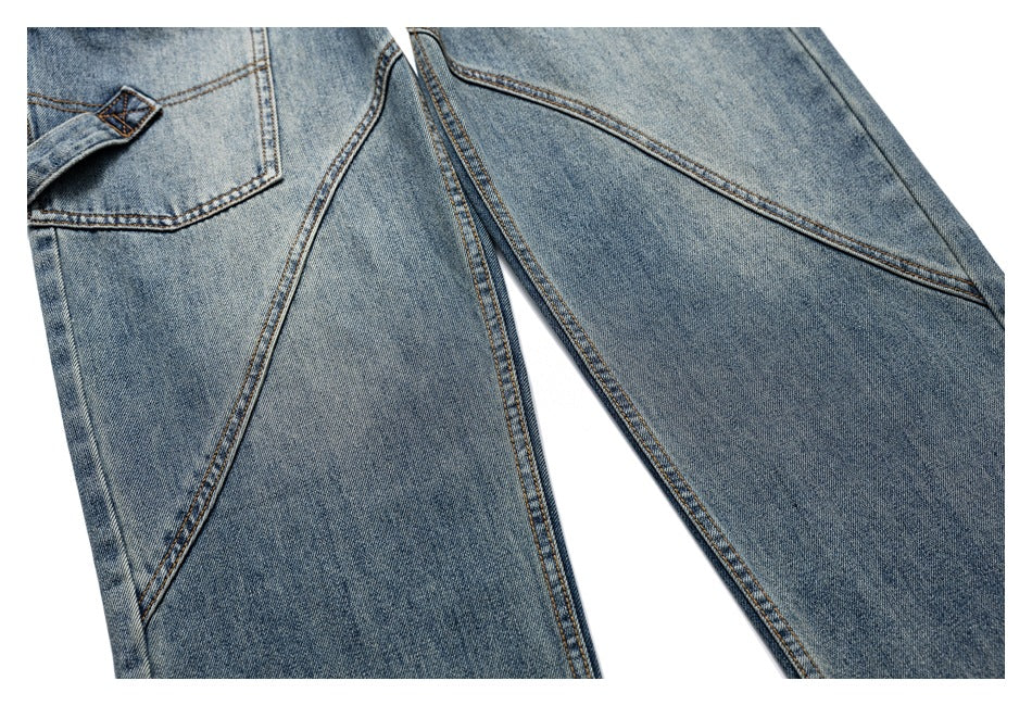 Close-up of medium-wash blue jeans showing a pocket edge and diagonal stitched seams.