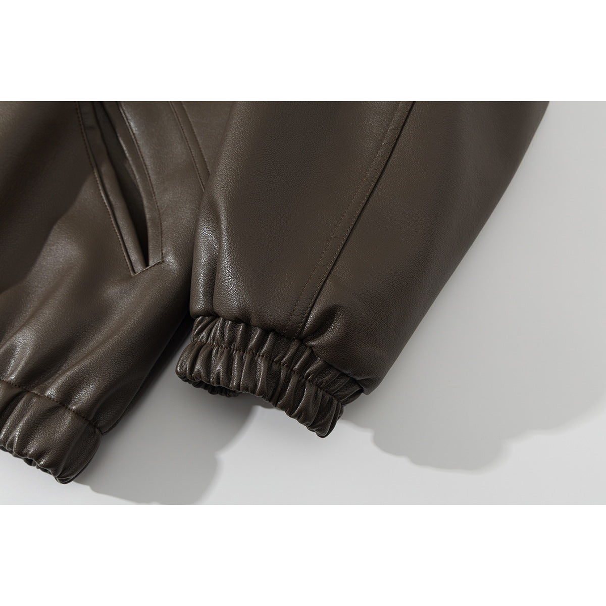 Close-up of the dark brown jacket’s long sleeves and gathered elastic cuffs.