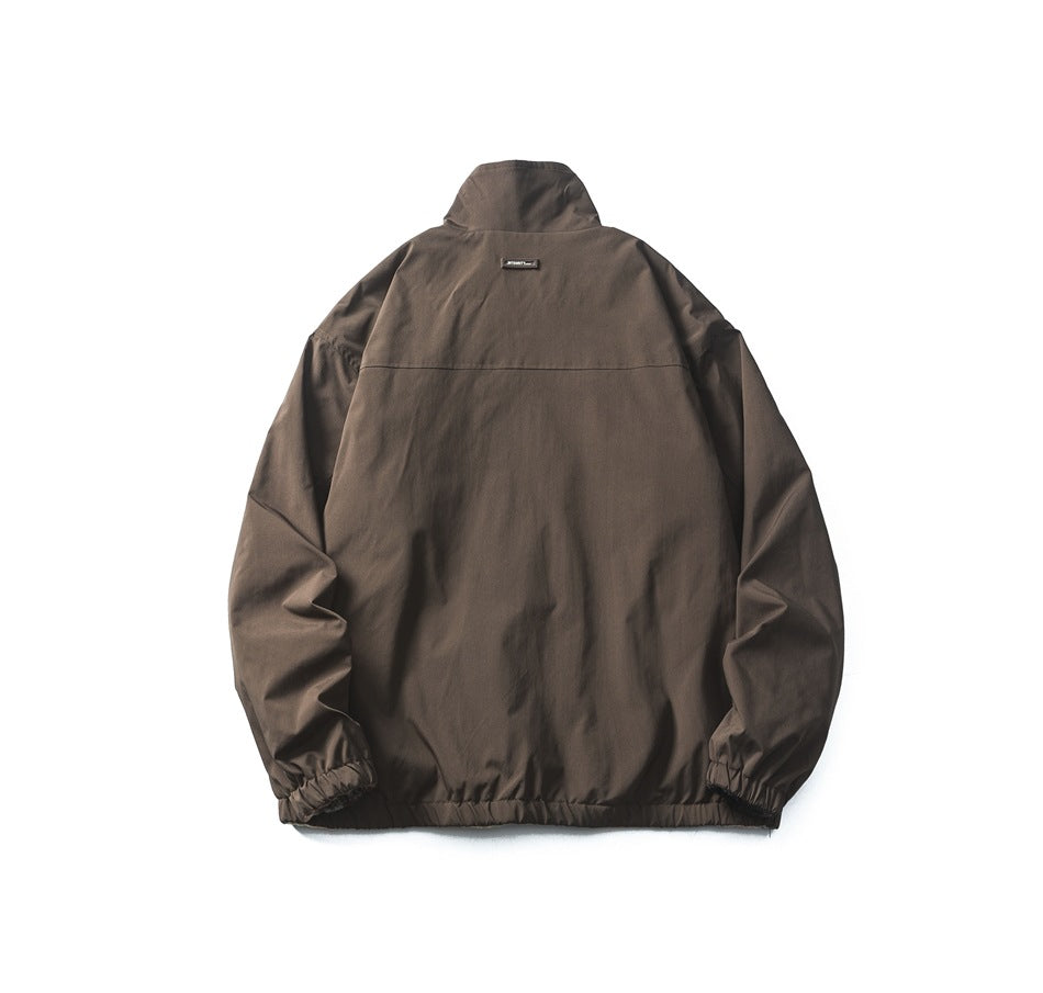 Back view of a dark brown jacket with a stand collar, seam across the shoulders, and gathered hem and cuffs.