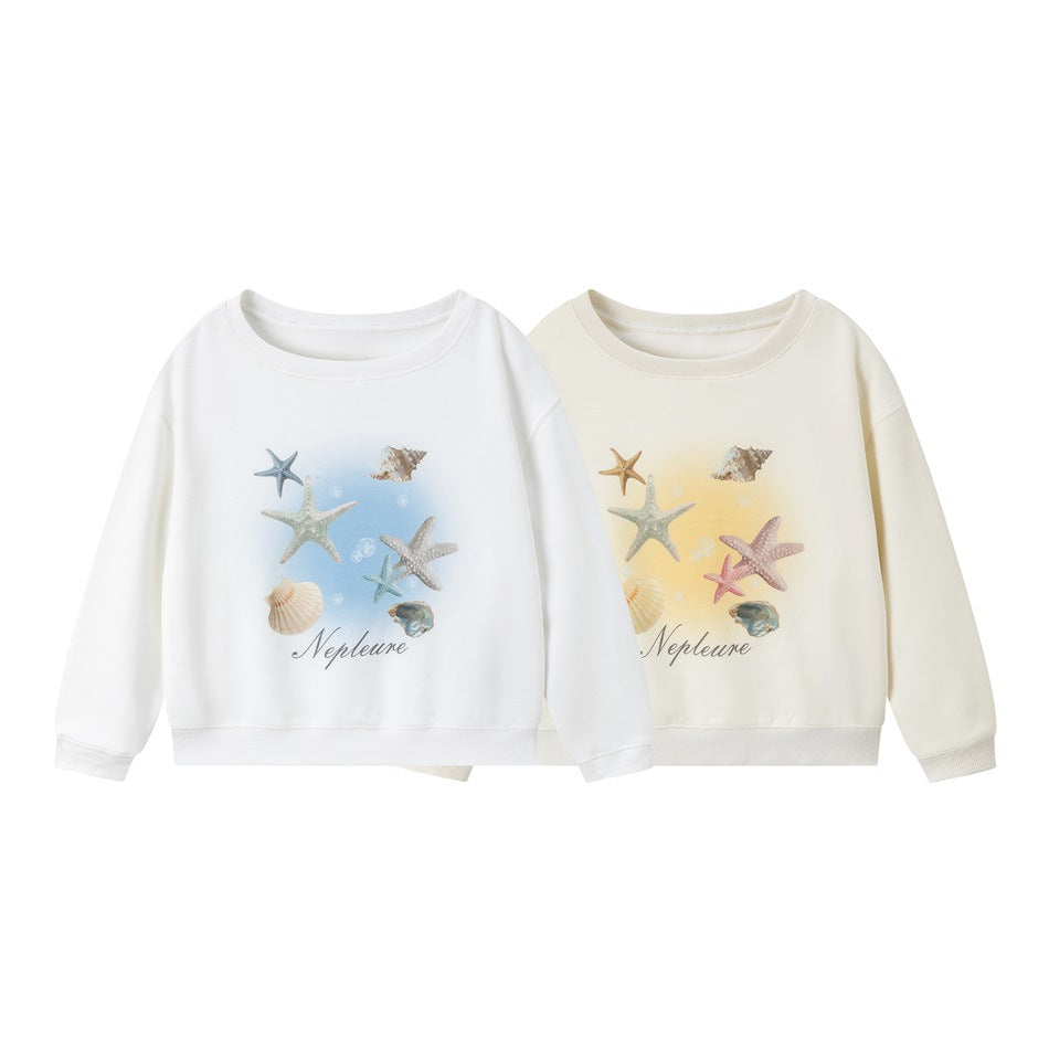Two crewneck sweatshirts shown from the front in white and cream, both with colorful starfish and shell prints.