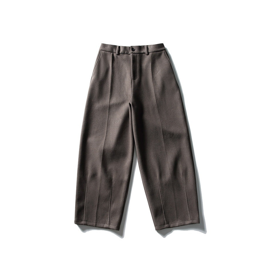 Brown wide-leg trousers flat lay, front view, with button fly, belt loops and pressed creases